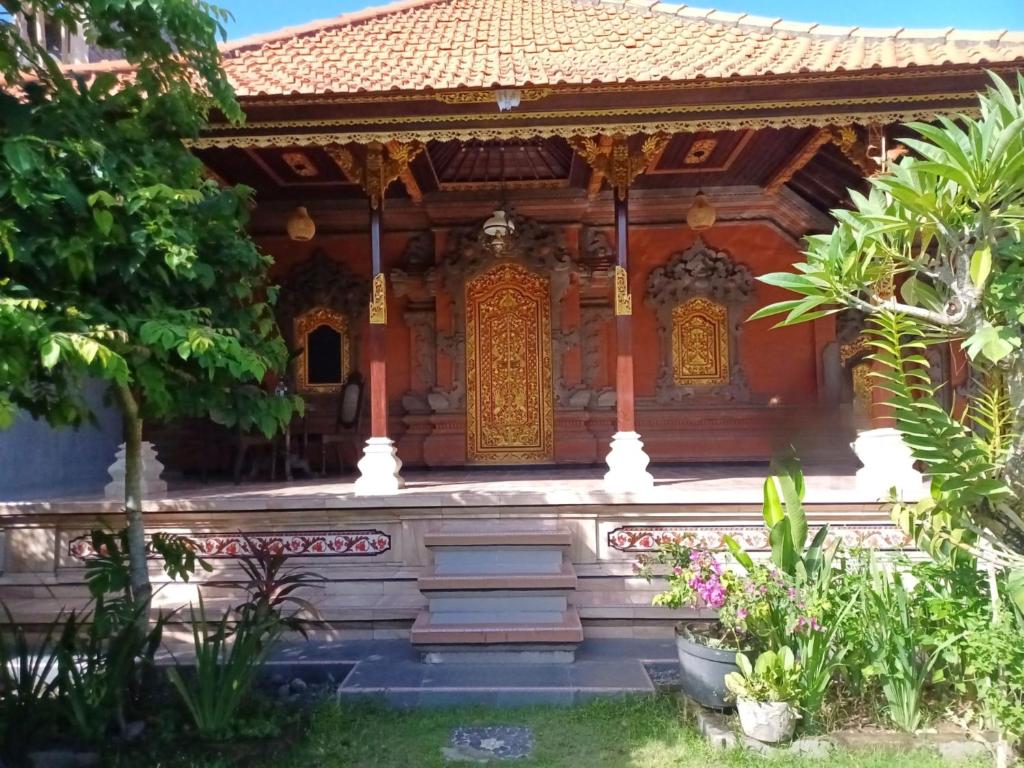 a temple in the middle of a garden at Rumah Bali Kelating in Krambitan