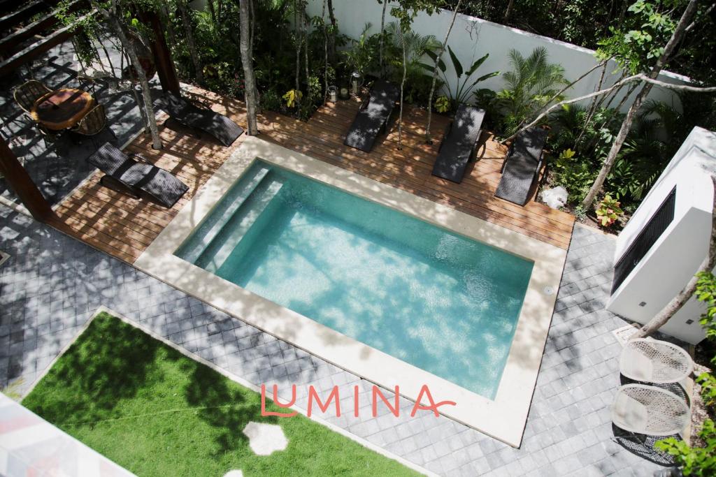 an overhead view of a swimming pool in a backyard at Lumina at Looltum Tulum in Tulum