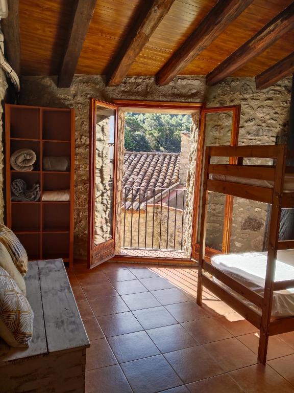a room with a bed and a window with a view at El Refugi in Arboli