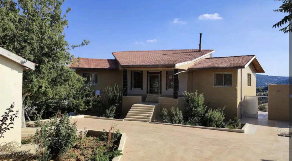 a house with a view of a mountain at Mountain farm in Ajloun