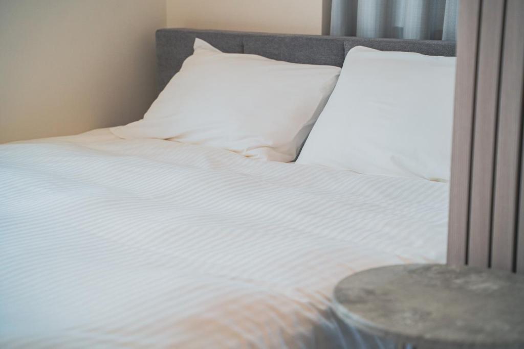 Postel nebo postele na pokoji v ubytování Star Residence - 博多上呉服