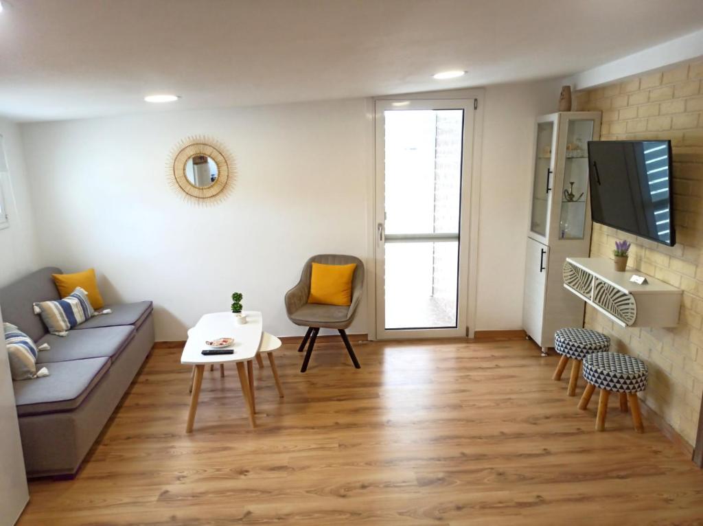 een woonkamer met een bank en een tafel bij Renovated Loft near the Center in Heraklion