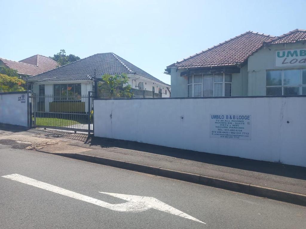 a white fence in front of a house at Umbilo Bed and Breakfast 08 Rick Turner in Durban