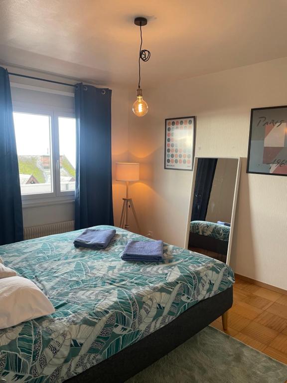 a bedroom with a bed and a window and a mirror at Amazing lake view Montreux in Montreux