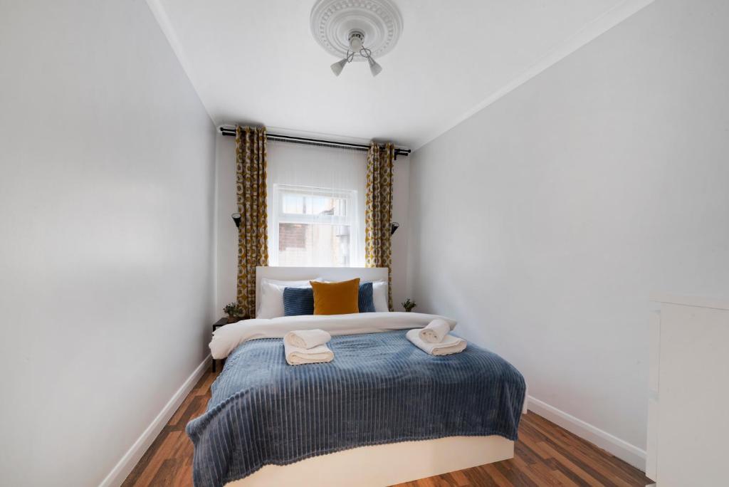 a bedroom with a bed with two towels on it at Old Street Apartments By Morethanstays in London