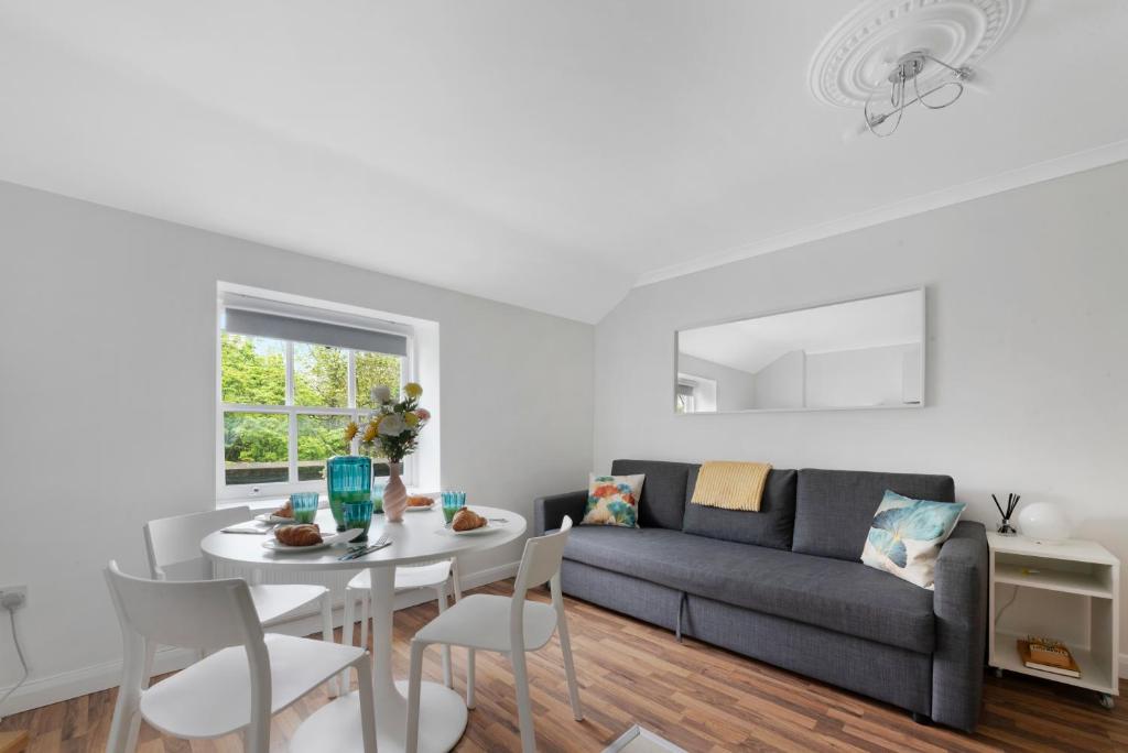 a living room with a couch and a table at Old Street Apartments By Morethanstays in London