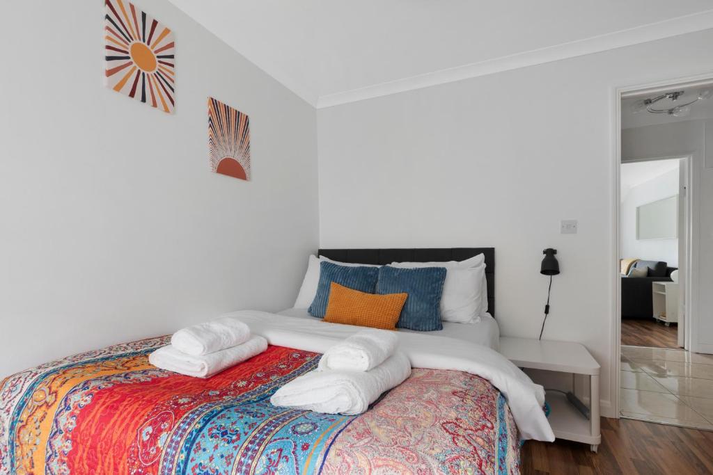 a bedroom with a bed with towels on it at Old Street Apartments By Morethanstays in London