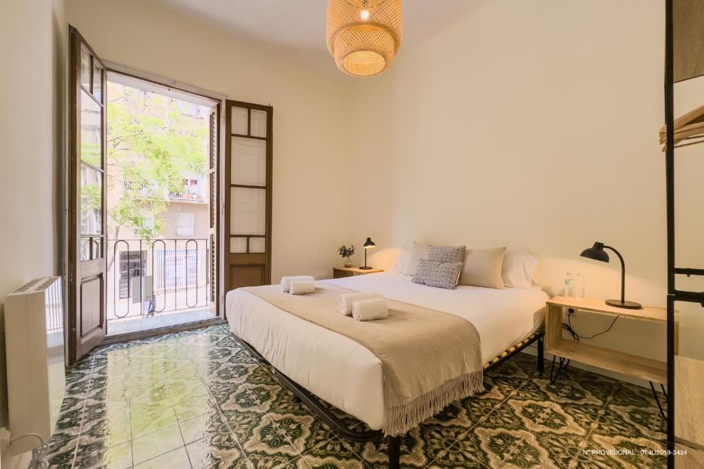 a bedroom with a bed and a large window at Sagrada Familia 360 in Barcelona