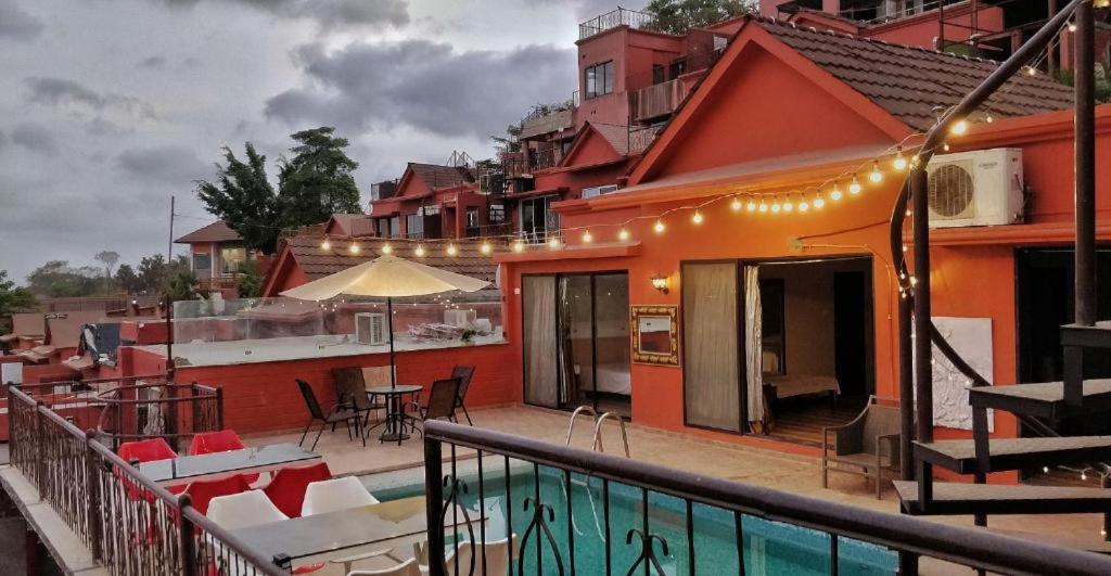 a balcony of a house with a table and chairs at Spruce Peak Villa in Mumbai