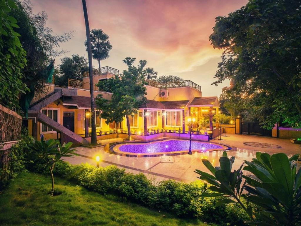 a house with a swimming pool in a yard at Shore Beats Villa in Mumbai