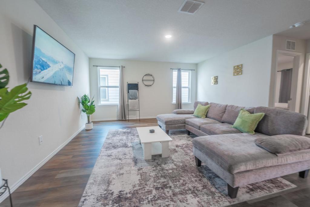 a living room with a couch and a coffee table at Charming Home near Seaworld in Helotes