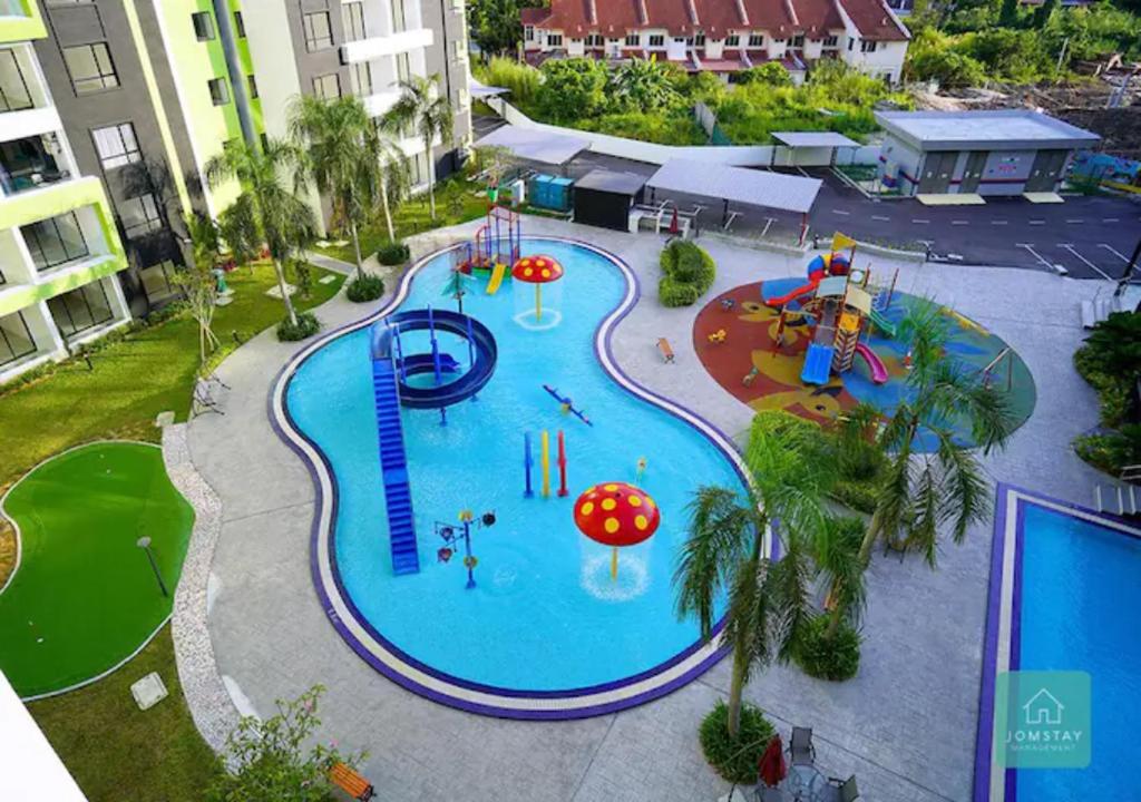 an overhead view of a swimming pool at a resort at Jomstay Manhattan Suites Ipoh Water Park Homestay in Ipoh