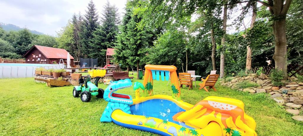 un parque infantil con un tren de juguetes en la hierba en Szymusiowa Szczyrk en Szczyrk