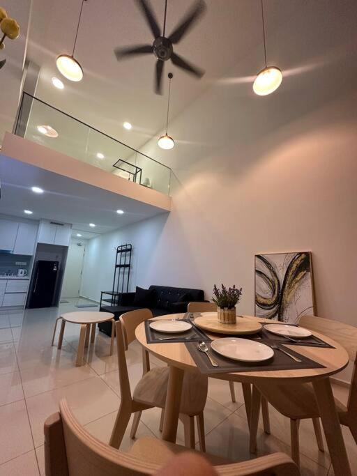 a dining room with a table and chairs and a ceiling fan at 2 Guest Duplex City Center Eko Cheras Mall Kuala Lumpur Pavilion Bukit Bintang KLCC Petaling Street Central Market National Zoo Batu Caves Merdeka Square in Kuala Lumpur