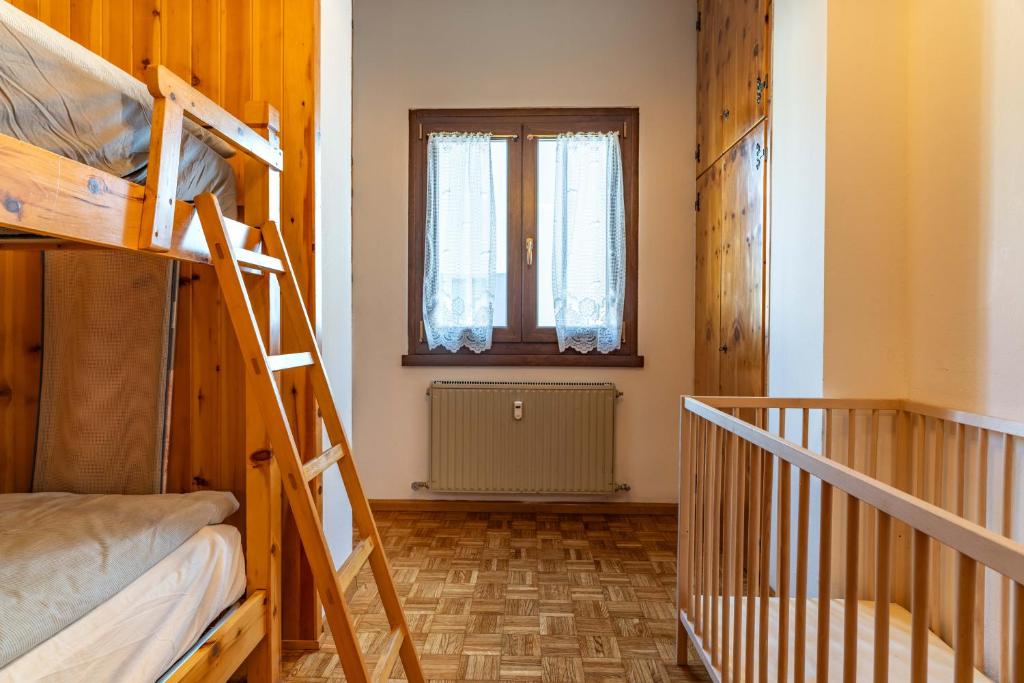 Postel nebo postele na pokoji v ubytování Trilo Luce della Paganella