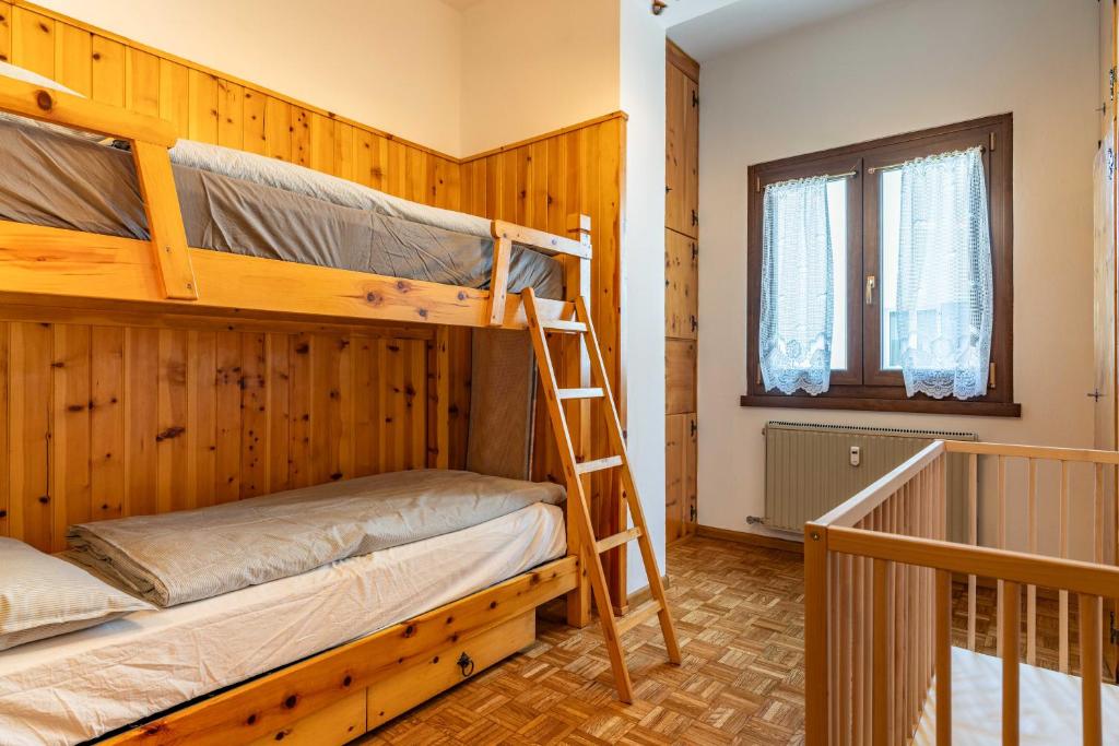 Postel nebo postele na pokoji v ubytování Trilo Luce della Paganella