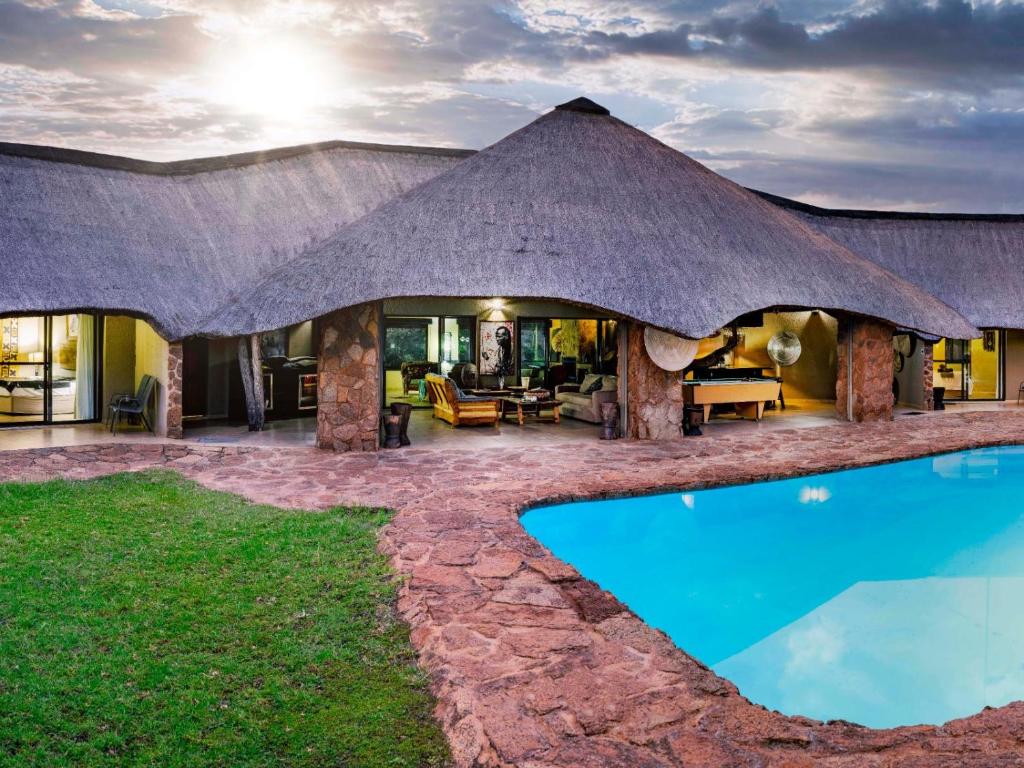 an image of a house with a swimming pool at Sable Ranch Bush Lodge in Brits