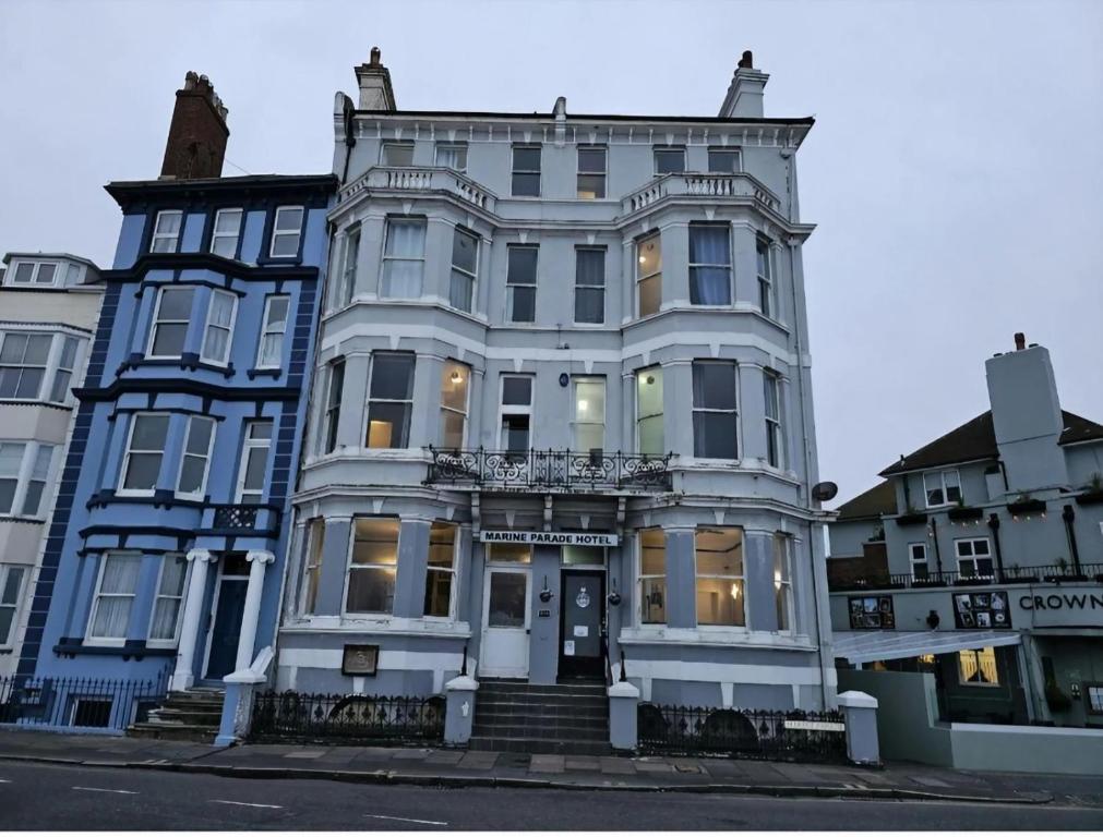 a large white building on the corner of a street at OYO Marine Parade Hotel, Eastbourne Pier in Eastbourne