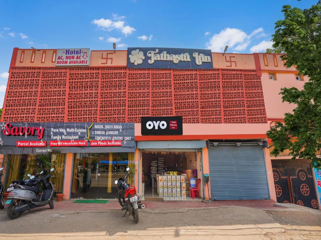 a building with two motorcycles parked in front of it at OYO Tathastu Inn in Raipur