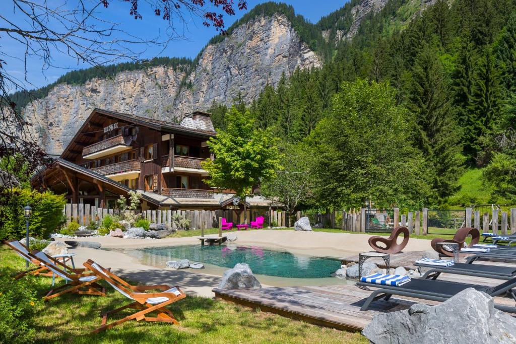 a resort with a pool and a house at le A by neige et roc in Morzine