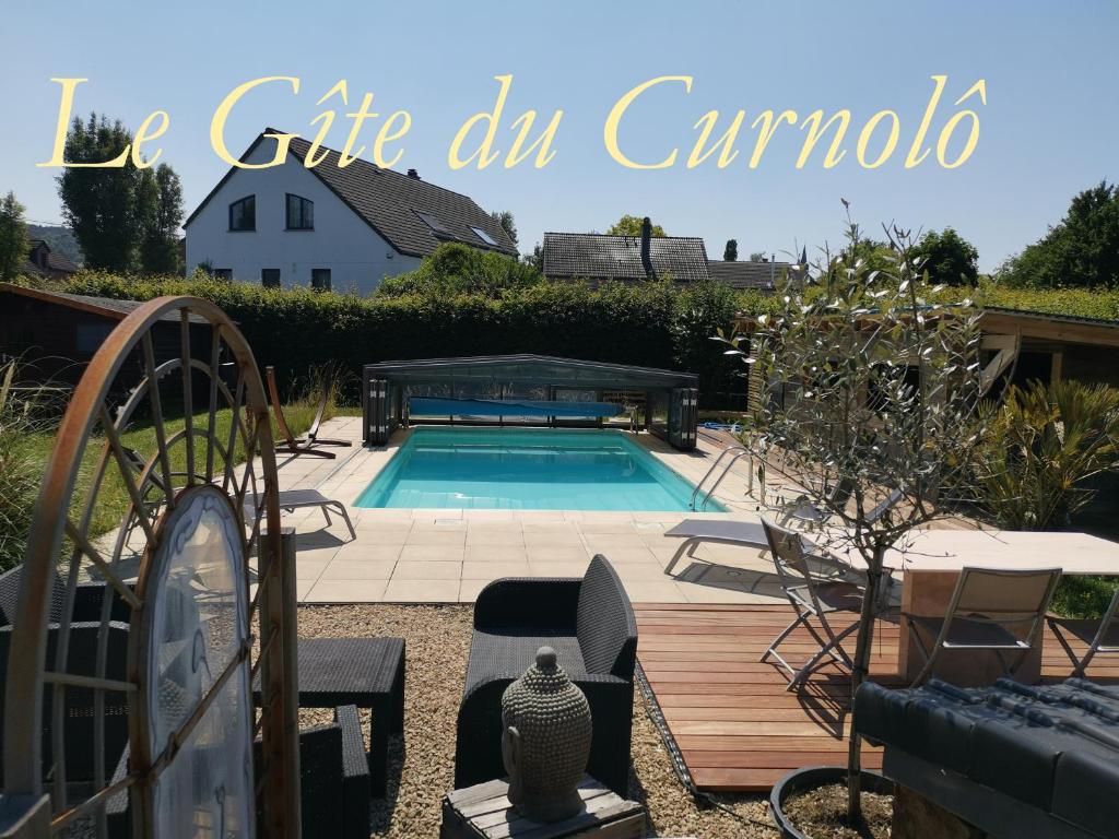 una piscina en un patio con mesa y sillas en Gîte coquet 2 chambres, 2 salles de douches avec piscine, spa en Namur