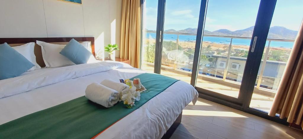 a bedroom with a bed with two stuffed animals on it at Sky Seaview Coron in Coron