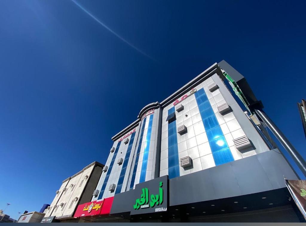 a building with blue windows on a clear blue sky at شقق ذوق الخيآل المخدومه الحبله in Abha