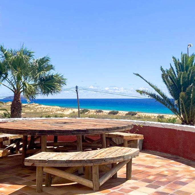a wooden picnic table with a view of the ocean at Porto Santo Destination in Porto Santo