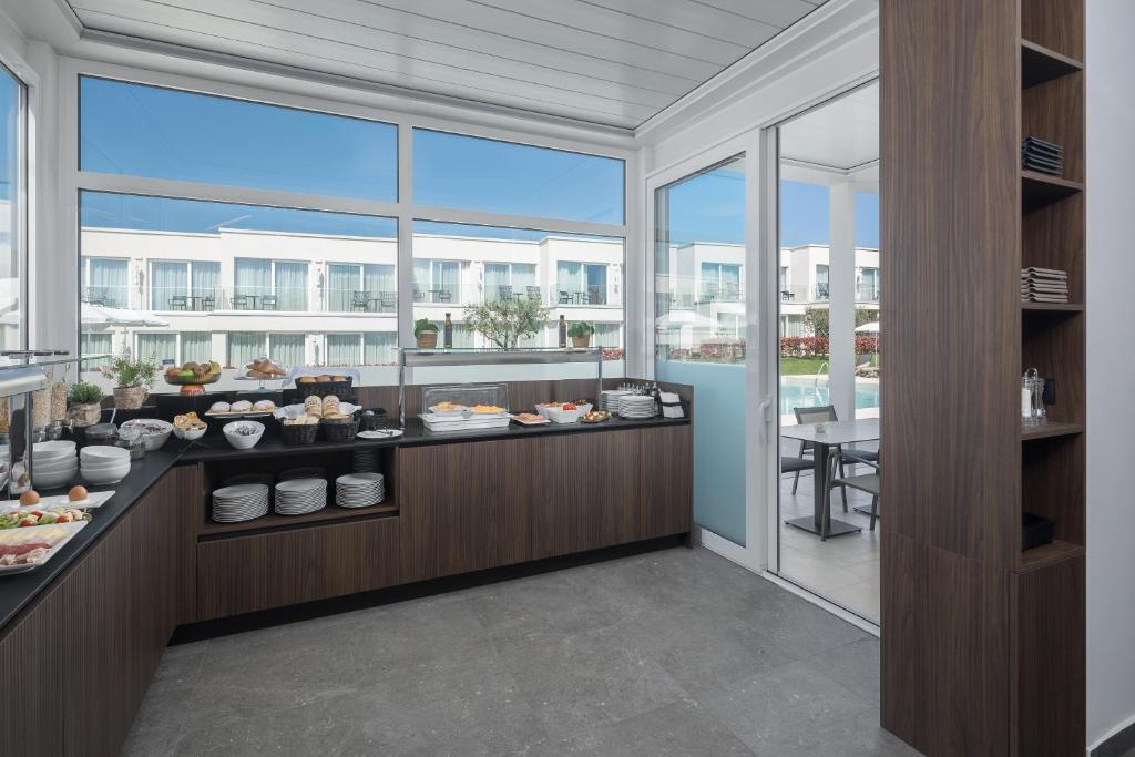 a restaurant with a buffet of food on a counter at Maj Luxury Residence in Poreč