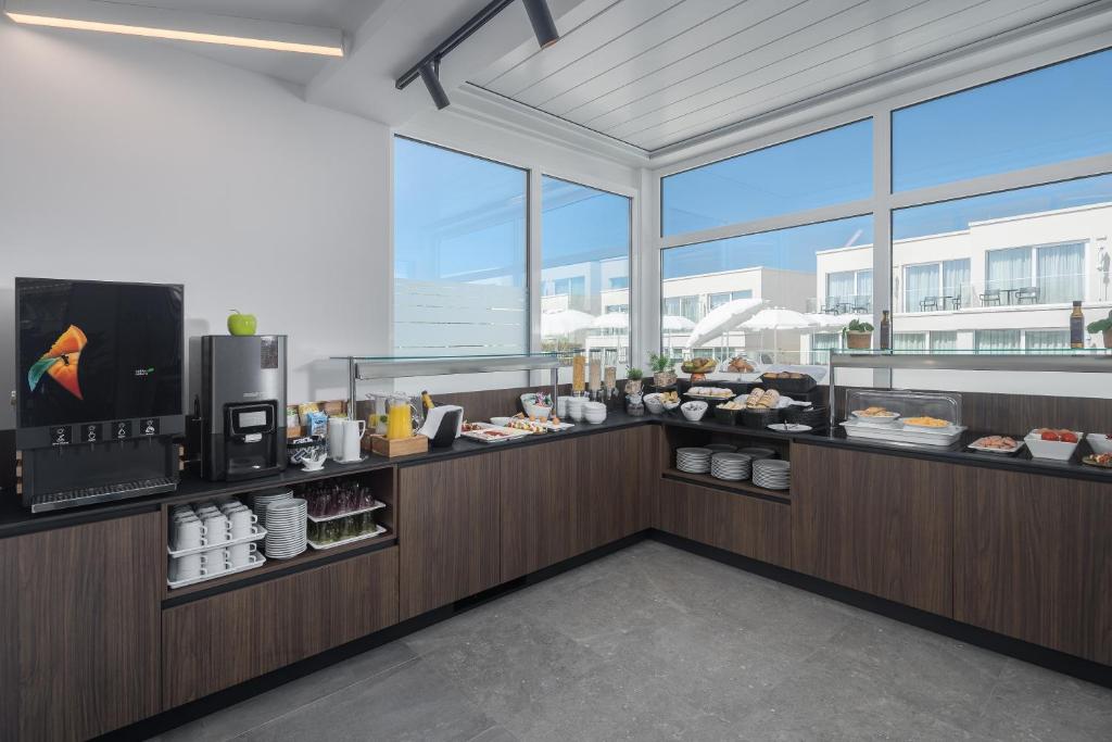 a restaurant with a buffet line with food at Maj Luxury Residence in Poreč