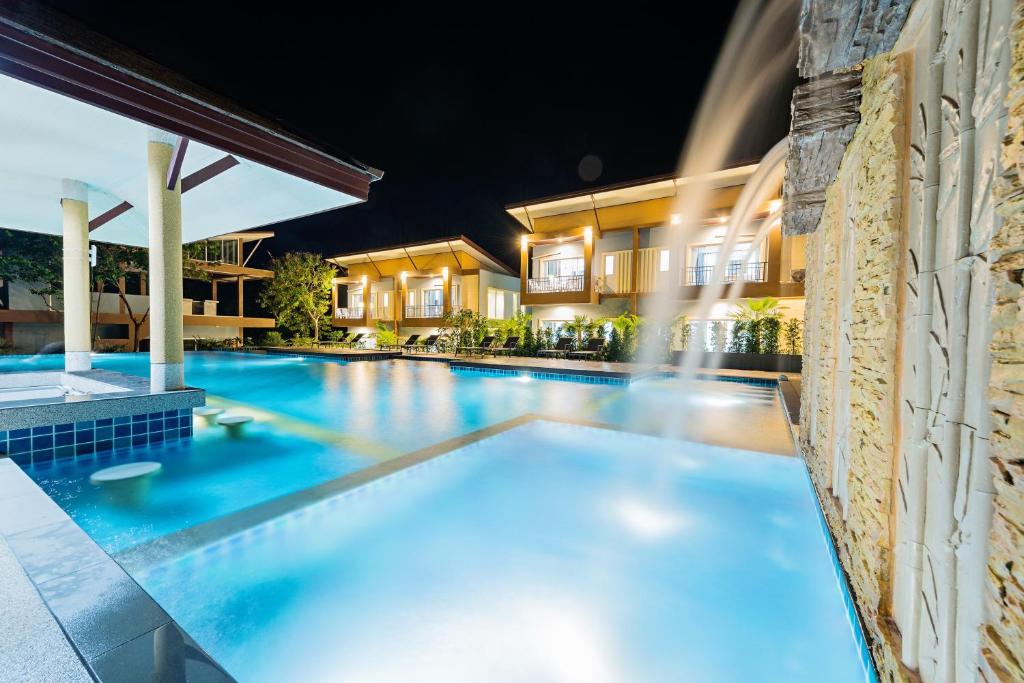 a swimming pool in a villa at night at Phutara Lanta Resort - SHA Extra Plus Koh Lanta in Ko Lanta