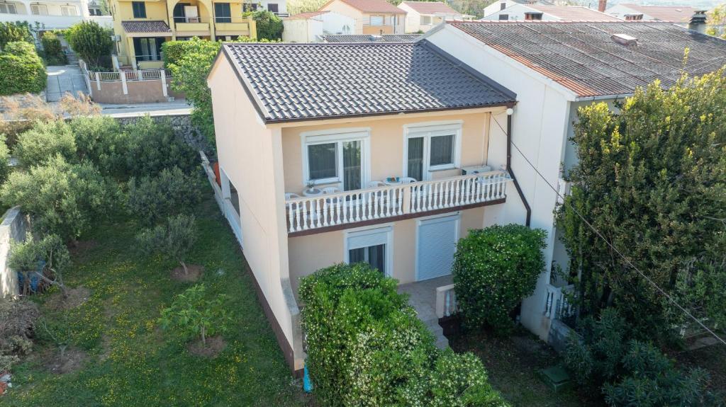 an aerial view of a white house with a balcony at Apartment Wish - two bedrooms with 2 AC renewed in Pag