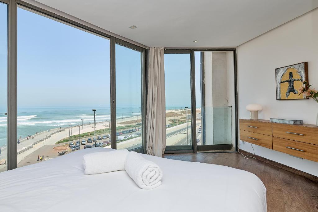 a bedroom with a bed and views of the beach at Sea View & Hassan 2 Mosque By TheCasaEdition (B18) in Casablanca