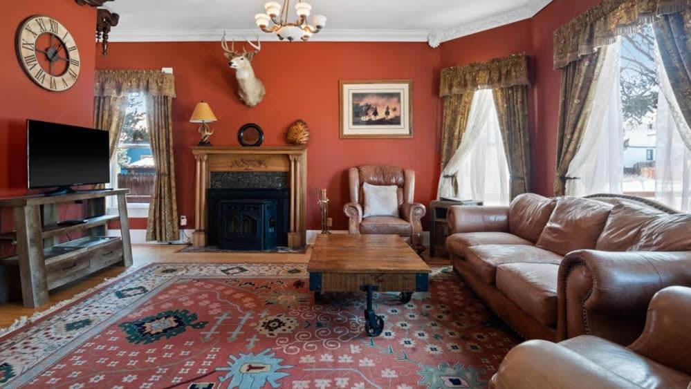 a living room with a couch and a fireplace at Governor's Mansion beautiful 3bd with pool table in Leadville