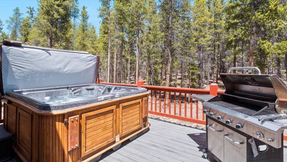 a grill and a barbecue on a deck at Mountain Home with Amazing Views and Hot Tub in Leadville