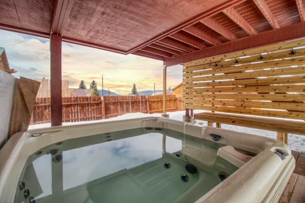 a hot tub on the deck of a house at Leadville Dairy Flat - 2 Bed with Office and HOT TUB in Leadville