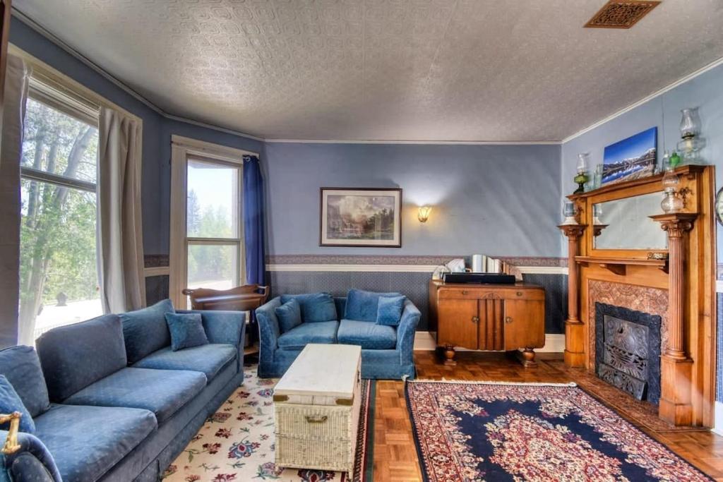 a living room with blue couches and a fireplace at The Victorian Aspen Grove- 2bd w Sauna & Gym in Leadville