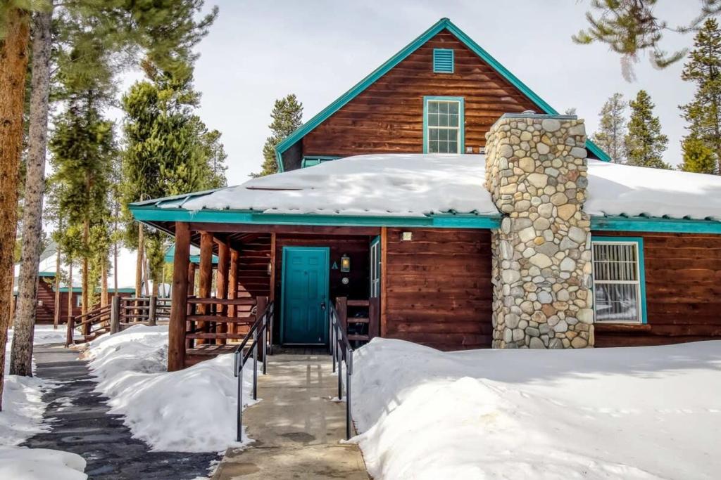 a log cabin in the snow with a blue door at Lackawanna 1A in Leadville
