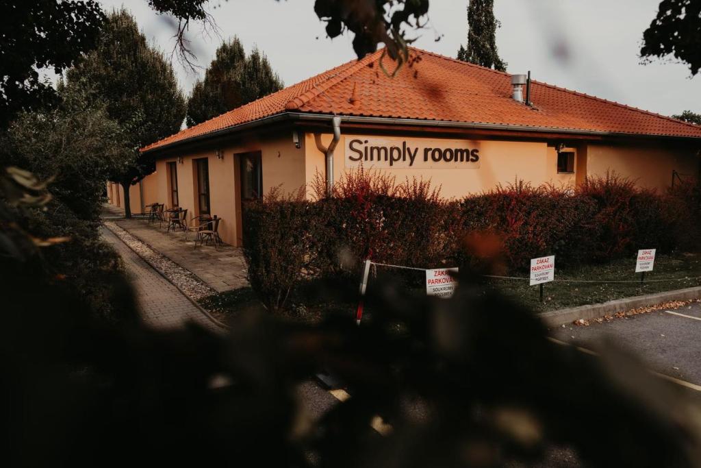 a building with a sign that reads simply rooms at Simply rooms in Slavkov u Brna
