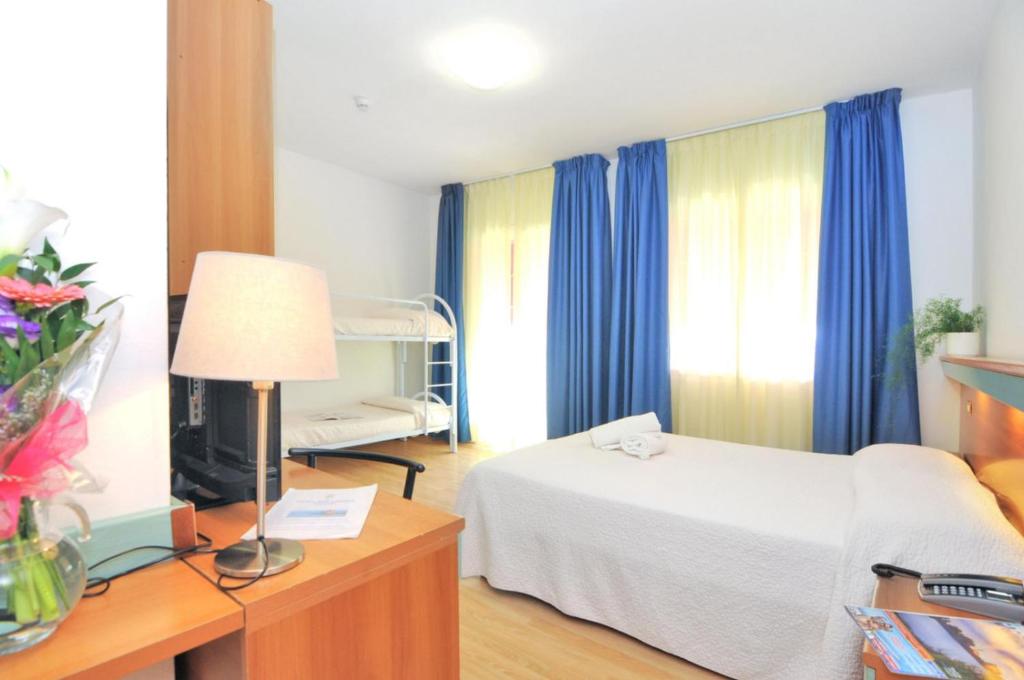 Postel nebo postele na pokoji v ubytování Hotel Rex