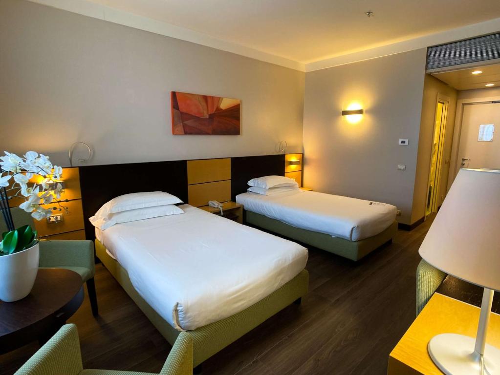 Łóżko lub łóżka w pokoju w obiekcie Best Western Plus Hotel Le Favaglie