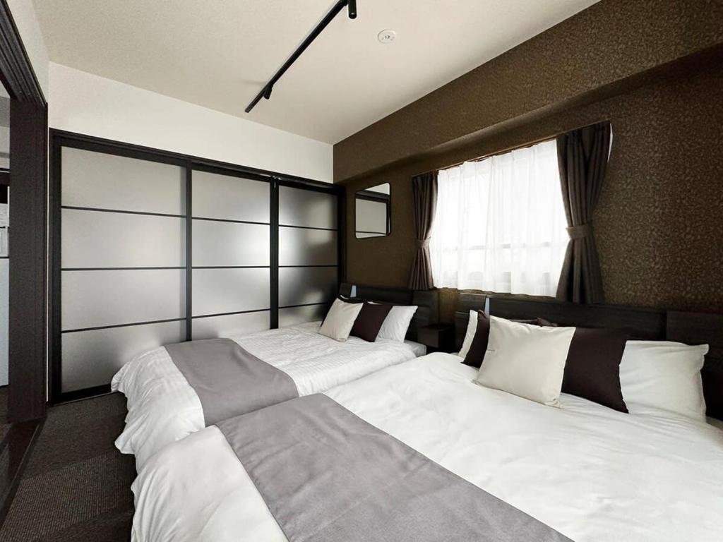 Postel nebo postele na pokoji v ubytování bHOTEL Nagomi - Large 2BR Apt City Center for 10 Ppl