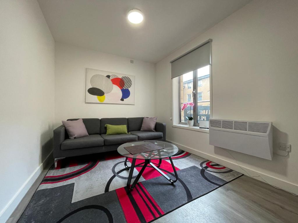 a living room with a couch and a table at Downtown Sheffield Retreat in Sheffield