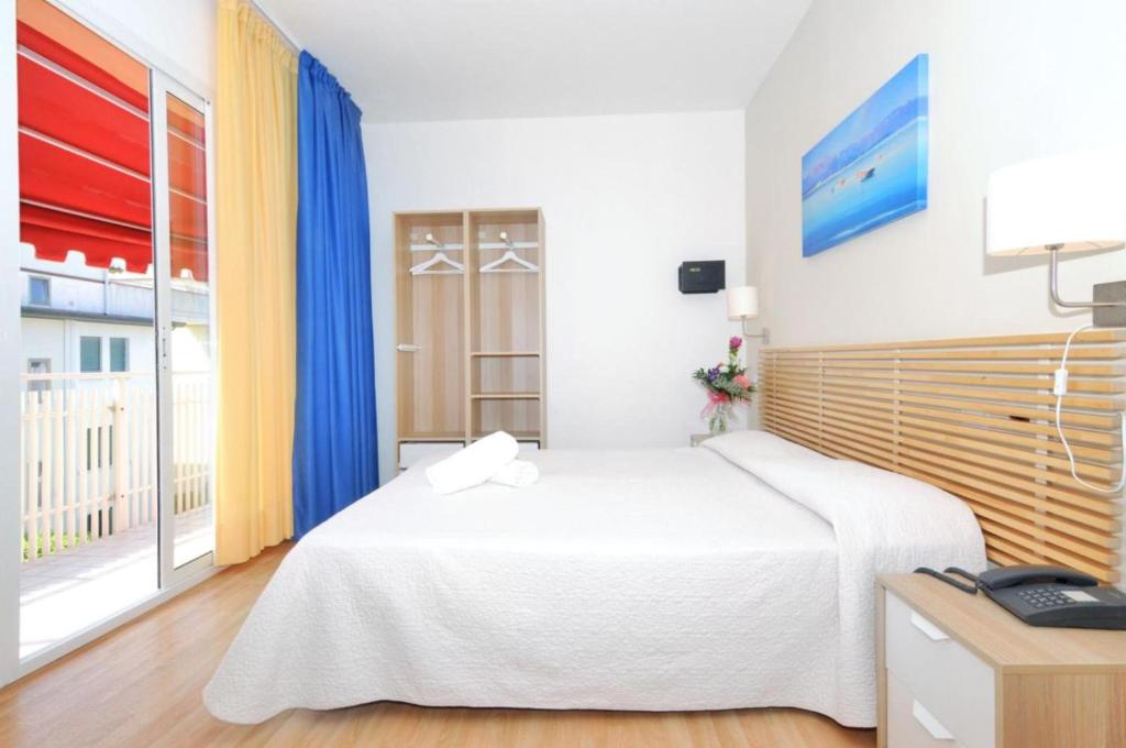 Postel nebo postele na pokoji v ubytování Hotel Rex