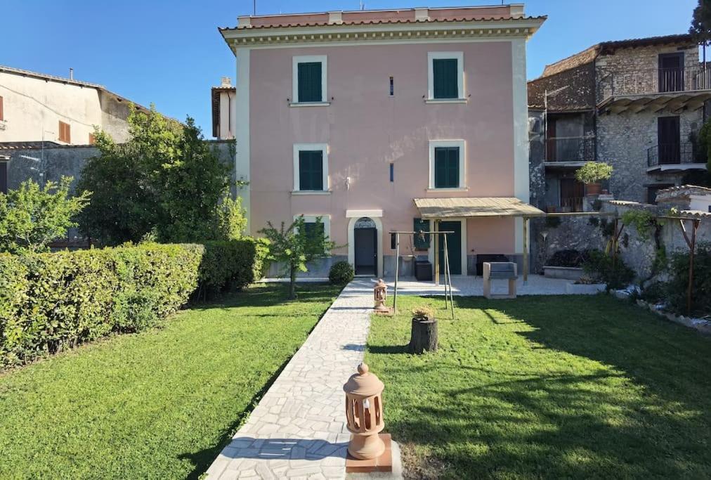 a house with a fire hydrant in front of it at Il covo degli Amanti in Fara in Sabina