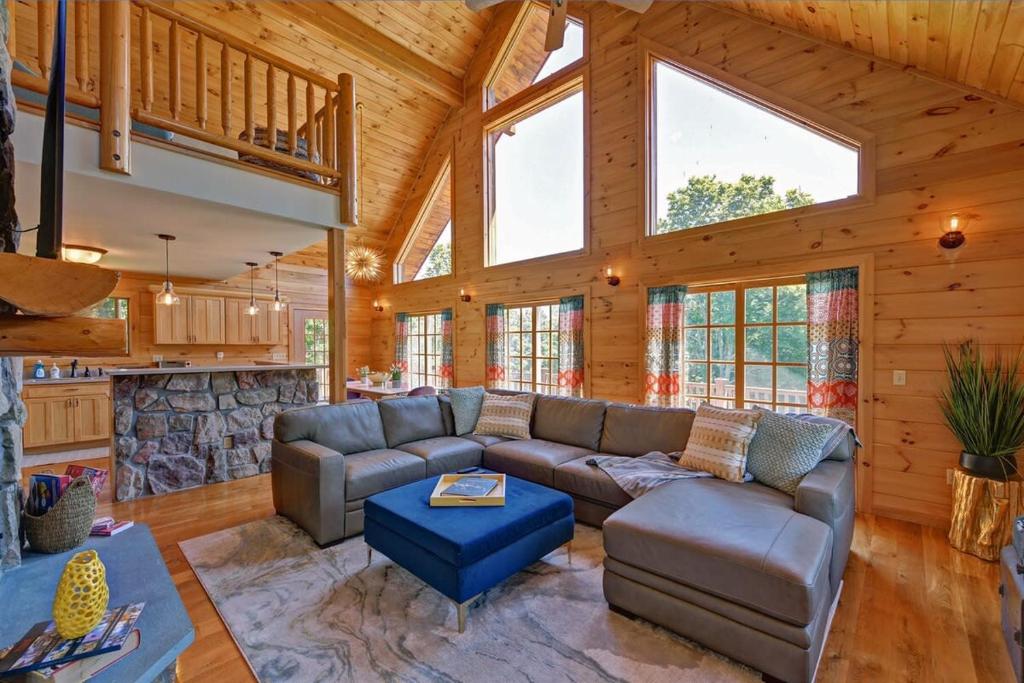 a living room with a couch and a fireplace at Berkshire Vacation Rentals: Great Barrington Cabin Sleeps 14 Walk To Town in Great Barrington