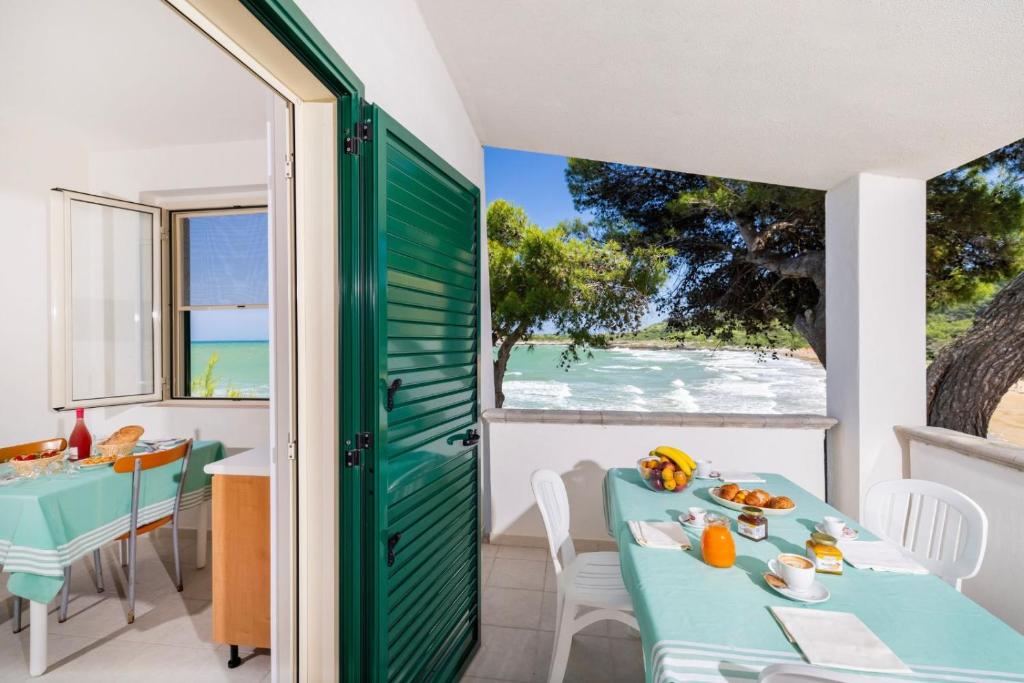 a dining room with a table and a view of the ocean at Crovatico Centro Vacanze in Vieste