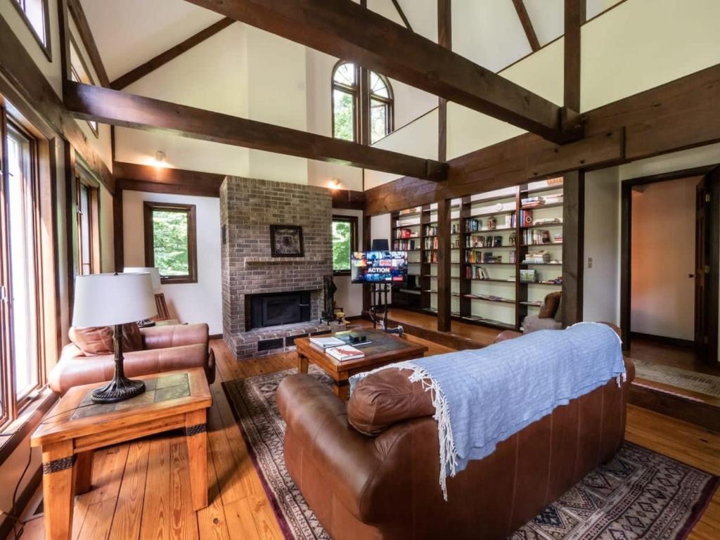 a living room with a couch and a fireplace at Berkshire Vacation Rentals: Pristine Home In Becket Woods in Becket