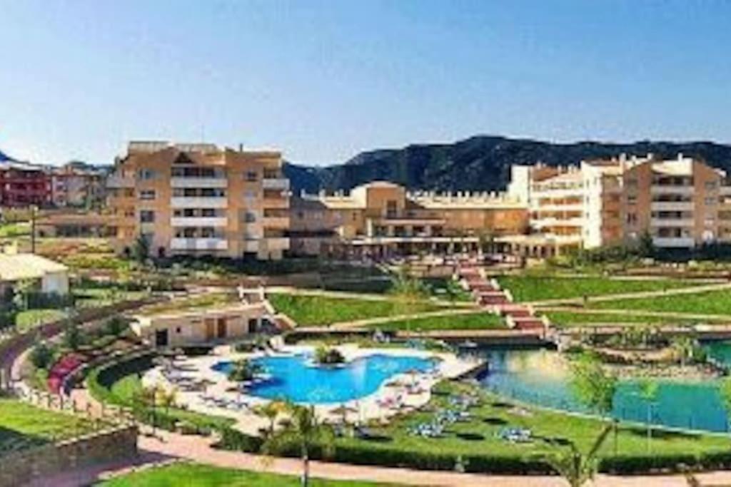 un complejo con 2 piscinas y algunos edificios en Encanto Apartamento Sol Andalusí, en Alhaurín de la Torre