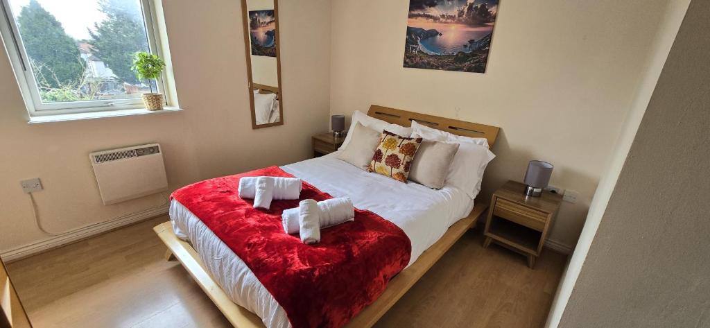 a bedroom with a bed with two towels on it at SAV Apartment one bed Flat Uxbridge in Uxbridge